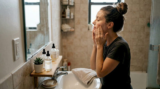 Woman doing morning natural skincare at bathroom sink
