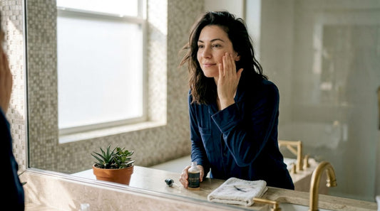 Woman applying skincare at bathroom counter